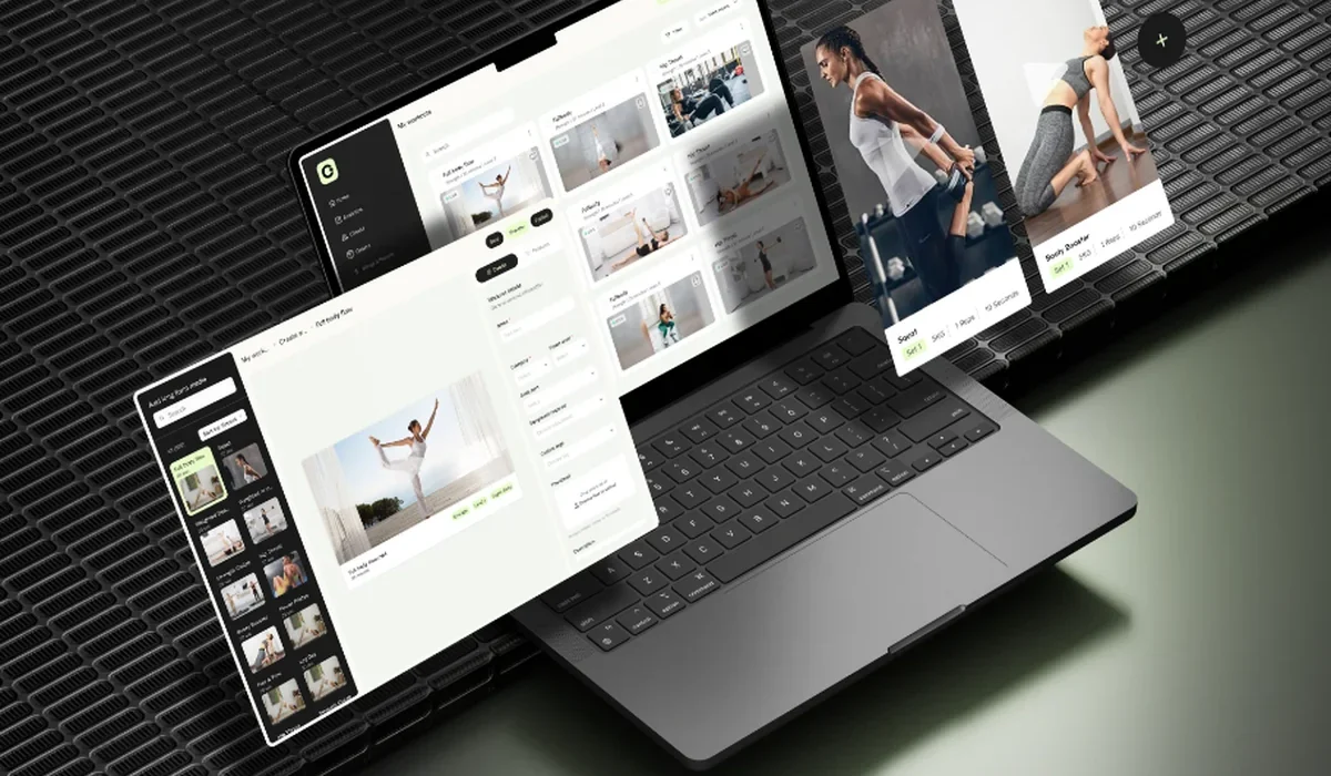 Online fitness coaching platform with workout video library on laptop