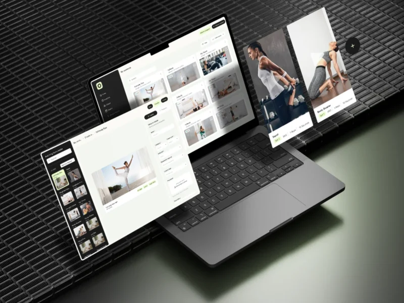 Online fitness coaching platform with workout video library on laptop